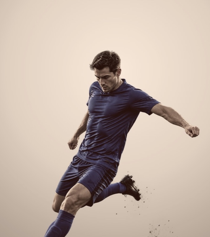 A footballer striking the ball